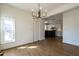 Dining area featuring hardwood floors, a chandelier, and an open view to the renovated kitchen at 118 Riverwood Dr, Fuquay Varina, NC 27526