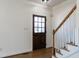 Bright entryway with hardwood floors, a wooden door, and a staircase at 118 Riverwood Dr, Fuquay Varina, NC 27526