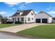 Exterior view of a charming home and lush front lawn featuring an attached garage at 118 Riverwood Dr, Fuquay Varina, NC 27526