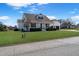 Traditional home with a neatly kept lawn, large trees, and a white picket fence at 118 Riverwood Dr, Fuquay Varina, NC 27526
