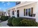Inviting front porch with wood decking, stylish columns, decorative shutters, and a swing at 118 Riverwood Dr, Fuquay Varina, NC 27526