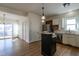 Open kitchen with white cabinets, stainless steel appliances, and hardwood floors at 118 Riverwood Dr, Fuquay Varina, NC 27526