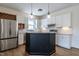 Modern kitchen featuring white cabinets, stainless appliances, and an island with seating at 118 Riverwood Dr, Fuquay Varina, NC 27526