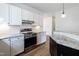 Renovated kitchen with stainless steel oven and range, white cabinets, granite countertops, and subway tile at 118 Riverwood Dr, Fuquay Varina, NC 27526