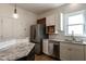 Updated kitchen with stainless steel refrigerator, white cabinets, granite counters and backsplash, and wine rack at 118 Riverwood Dr, Fuquay Varina, NC 27526