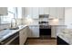 Bright kitchen with white cabinets, stainless steel appliances, and a marble countertop at 118 Riverwood Dr, Fuquay Varina, NC 27526