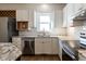 Bright kitchen with white cabinets, granite countertops, stainless steel appliances, and a window above the sink at 118 Riverwood Dr, Fuquay Varina, NC 27526