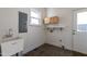 Functional laundry room features sink, cabinetry, and exterior access to backyard at 118 Riverwood Dr, Fuquay Varina, NC 27526