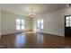 Sunlit living room featuring hardwood floors, a chandelier, and multiple windows at 118 Riverwood Dr, Fuquay Varina, NC 27526