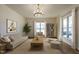 Cozy living room with neutral-toned furniture, a modern chandelier, and ample natural light at 118 Riverwood Dr, Fuquay Varina, NC 27526