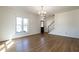 Inviting living room with hardwood floors, natural light, and an open staircase at 118 Riverwood Dr, Fuquay Varina, NC 27526