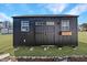 Durable outbuilding with shed roof and double doors set on a grassy area at 118 Riverwood Dr, Fuquay Varina, NC 27526