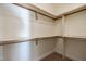 Spacious walk-in closet with custom shelving and wooden rods offer optimal storage solutions at 118 Riverwood Dr, Fuquay Varina, NC 27526