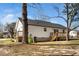 Exterior of the house featuring vinyl siding, a deck, and a spacious backyard at 120 W College St, Oxford, NC 27565