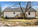 Backyard view showcasing the white vinyl siding of the house and a wooden deck at 120 W College St, Oxford, NC 27565