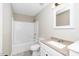 A bathroom with a tub and shower combo, toilet and single sink at 120 W College St, Oxford, NC 27565