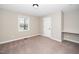 Bedroom featuring a window, a light, and tan carpet at 120 W College St, Oxford, NC 27565