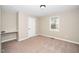 Neutral bedroom featuring a window, a light, and tan carpet at 120 W College St, Oxford, NC 27565