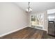 Bright dining area with sliding doors leading to the deck and stainless steel fridge at 120 W College St, Oxford, NC 27565