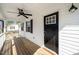 The front porch features a fan and black front door with glass windows at 120 W College St, Oxford, NC 27565