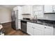 A close up of the stainless steel refrigerator, dishwasher, and granite sink at 120 W College St, Oxford, NC 27565