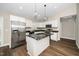 A kitchen featuring white cabinets, stainless steel appliances, and a granite island at 120 W College St, Oxford, NC 27565