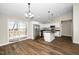 Bright kitchen with white cabinetry, stainless appliances, and a center island at 120 W College St, Oxford, NC 27565