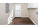 Mud room featuring dark wood floors, white walls, and a white door with glass at 120 W College St, Oxford, NC 27565