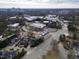 Expansive aerial view showcases the townhouses in a verdant urban setting at 1310 Chamblee Hill Ct, Raleigh, NC 27608