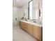 Spa-like bathroom with double vanity and modern fixtures at 1310 Chamblee Hill Ct, Raleigh, NC 27608