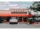 Street view of Village Deli and Grill restaurant, showcasing the parking, awning, and entrance at 1310 Chamblee Hill Ct, Raleigh, NC 27608