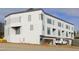 Modern townhouses with white exterior, dark trim, visible garages, and construction at 1310 Chamblee Hill Ct, Raleigh, NC 27608
