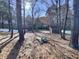 View of sprawling backyard with mature trees, detached structure, and white fencing at 138 Parkdale Ln, Clayton, NC 27520