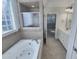Spa-like bathroom featuring a soaking tub, tiled shower, and double vanity sinks at 138 Parkdale Ln, Clayton, NC 27520