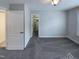 Serene bedroom featuring neutral colors and carpet, ample natural light, and a spacious closet at 138 Parkdale Ln, Clayton, NC 27520