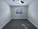 Bright bedroom featuring neutral carpet, a ceiling fan, and a window providing natural light at 138 Parkdale Ln, Clayton, NC 27520