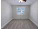Bright bedroom features neutral carpet, a ceiling fan, and a window providing natural light at 138 Parkdale Ln, Clayton, NC 27520