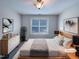 Staged primary bedroom with large window, closet and modern furnishings at 138 Parkdale Ln, Clayton, NC 27520