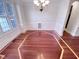 Elegant dining room showcasing beautiful hardwood floors, detailed trim, and a modern chandelier fixture at 138 Parkdale Ln, Clayton, NC 27520