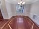 Elegant dining room showcasing beautiful hardwood floors, detailed trim, and a modern chandelier fixture at 138 Parkdale Ln, Clayton, NC 27520