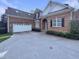 Brick home with 2-car garage, arched entryway, and professionally landscaped yard at 138 Parkdale Ln, Clayton, NC 27520
