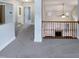 Hallway with railings offering an open view of the downstairs living area with fireplace at 138 Parkdale Ln, Clayton, NC 27520