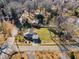 An aerial shot captures the home's position on a spacious lot with mature trees at 152 E Tryon St, Hillsborough, NC 27278