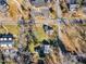 A serene aerial shot showcases an established neighborhood, complete with mature trees and neatly arranged homes at 152 E Tryon St, Hillsborough, NC 27278