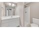 A well-lit bathroom features a single sink vanity, shower stall and toilet at 152 E Tryon St, Hillsborough, NC 27278