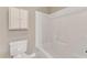 Bathroom featuring a shower/tub combo, toilet, and a white cabinet at 152 E Tryon St, Hillsborough, NC 27278