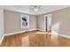 A spacious bedroom with a ceiling fan, hardwood floors, and a window for natural light at 152 E Tryon St, Hillsborough, NC 27278