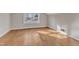 A bedroom with wood floors is lit by a central light and window at 152 E Tryon St, Hillsborough, NC 27278