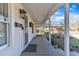 Inviting covered front porch with wood flooring, perfect for relaxing and enjoying the outdoors at 152 E Tryon St, Hillsborough, NC 27278