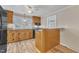 Functional kitchen featuring wooden cabinets, a ceiling fan, and ample counter space at 152 E Tryon St, Hillsborough, NC 27278